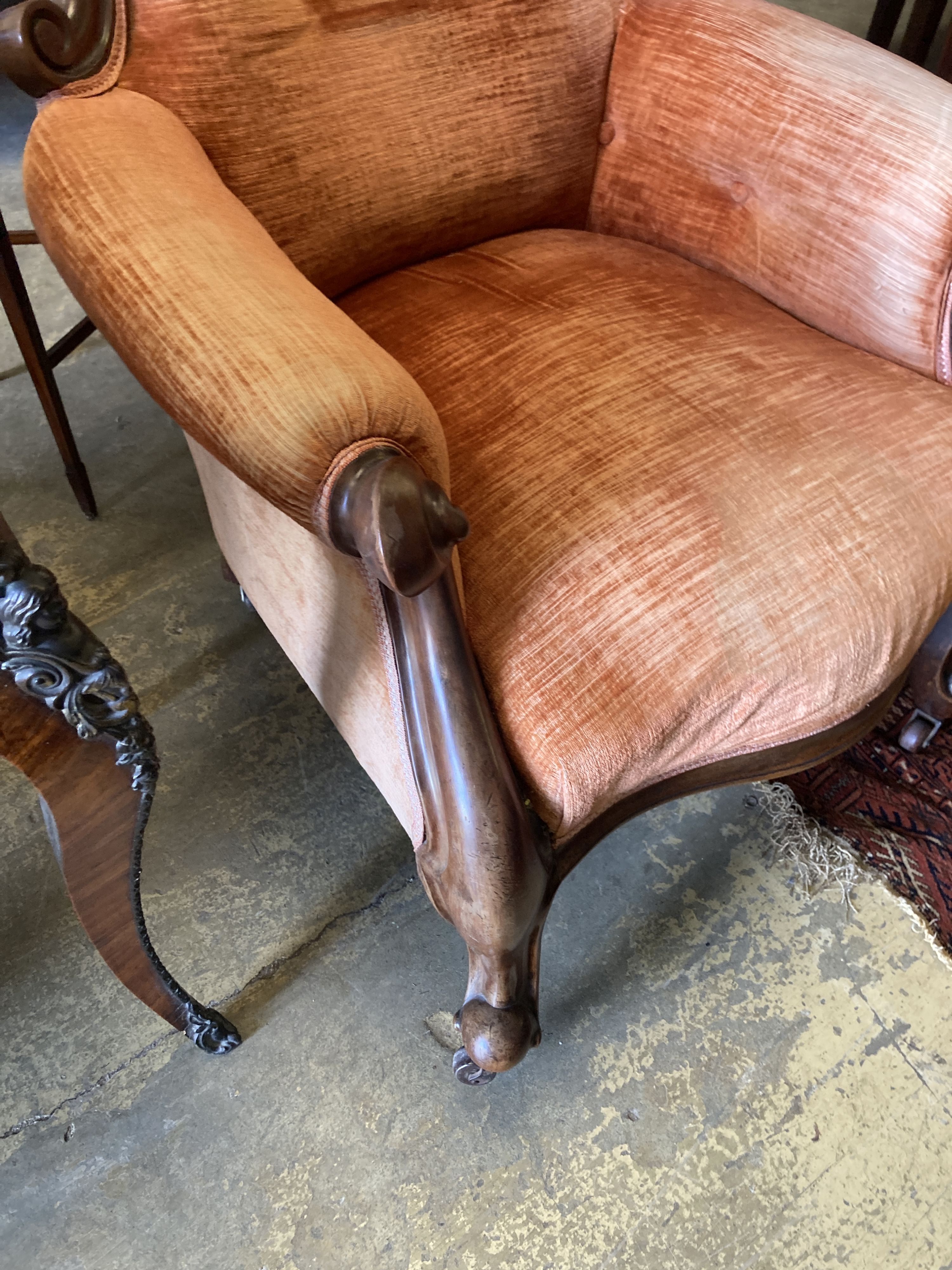 A Victorian carved mahogany spoonback armchair, width 72cm, depth 70cm, height 105cm